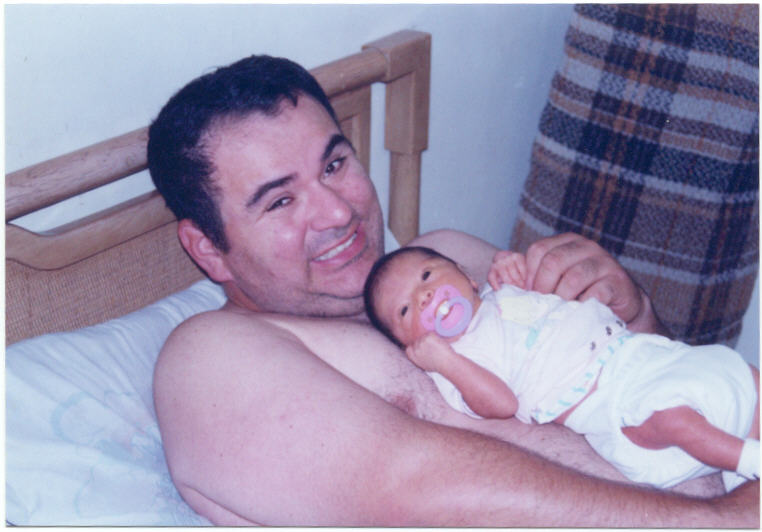 Daddy's chest is warm and cozy; Actual size=240 pixels wide